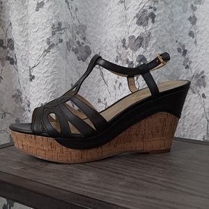 Women's black strapped heel wedge sandals.